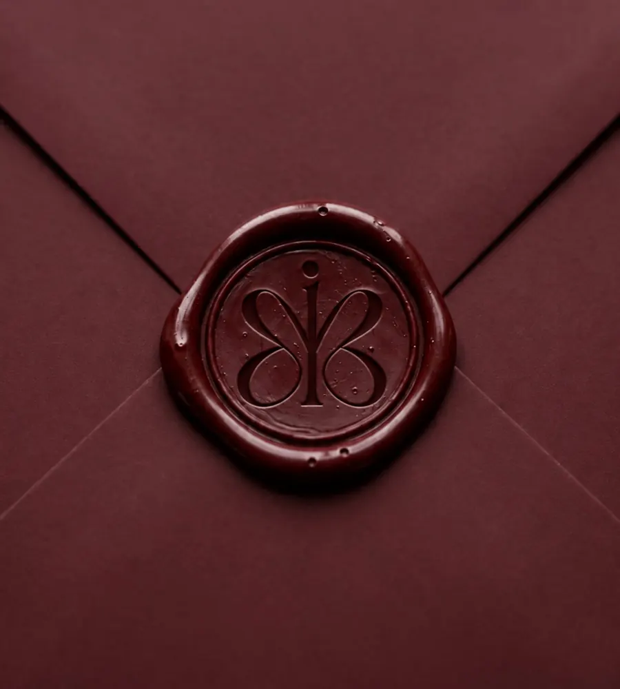 A burgundy envelope closed with a MarkIt wax seal